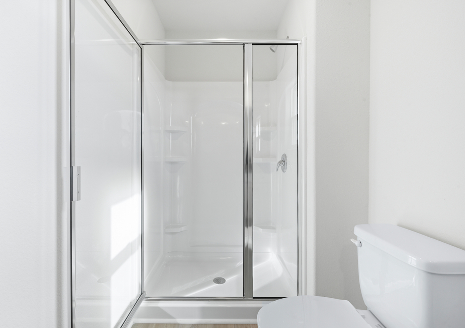 The master bedroom has a glass-enclosed shower