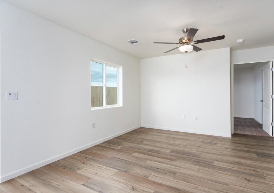 The family room is spacious and has a ceiling fan.