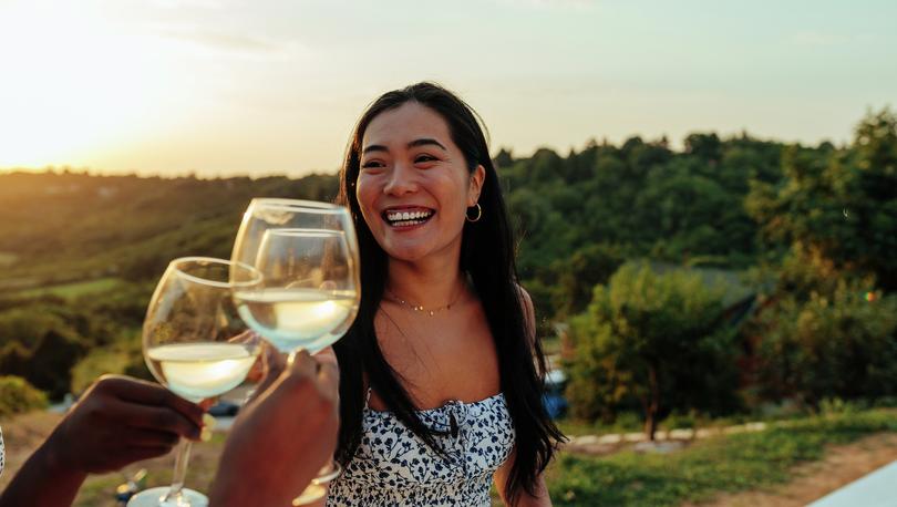 <p>Woman enjoying a glass of wine at a winery.</p>