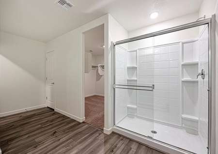 The master bath has a spacious, glass-enclosed shower.