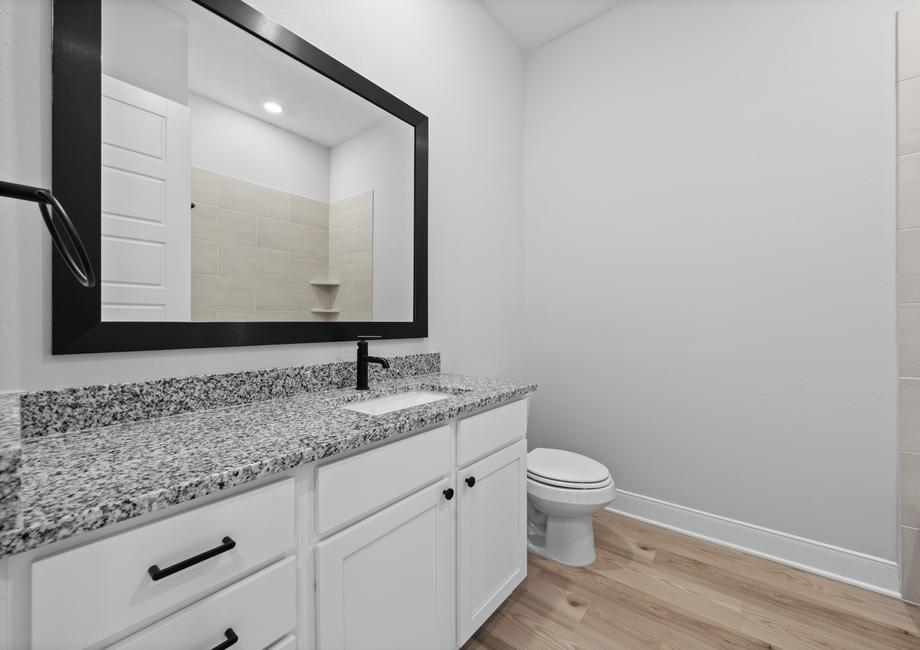 Enjoy granite countertops and framed mirrors in the secondary bathrooms.