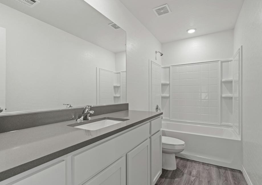 Secondary bathroom with large vanity and tub/shower combo