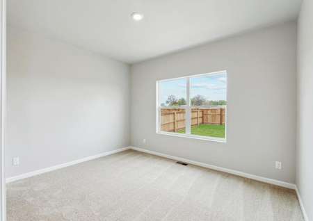The master bedroom has a great view of the fully-fenced back yard.