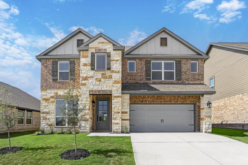 Exterior of the Sterling plan with stone and brick finishes.