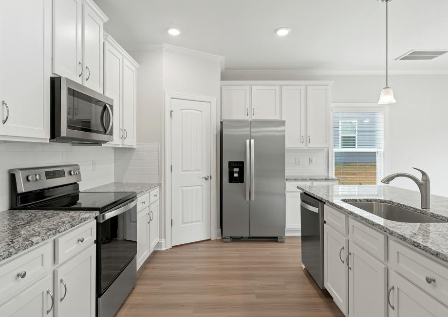 Kitchen with white cabinets and stainless appliances.