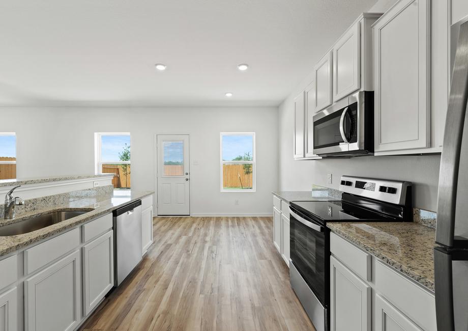 A full suite of stainless steel appliances in th ekitchen