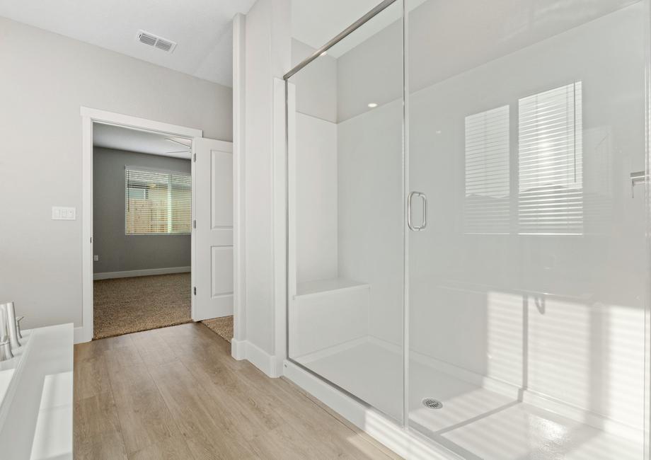 The master bath has a spacious, glass-enclosed shower.