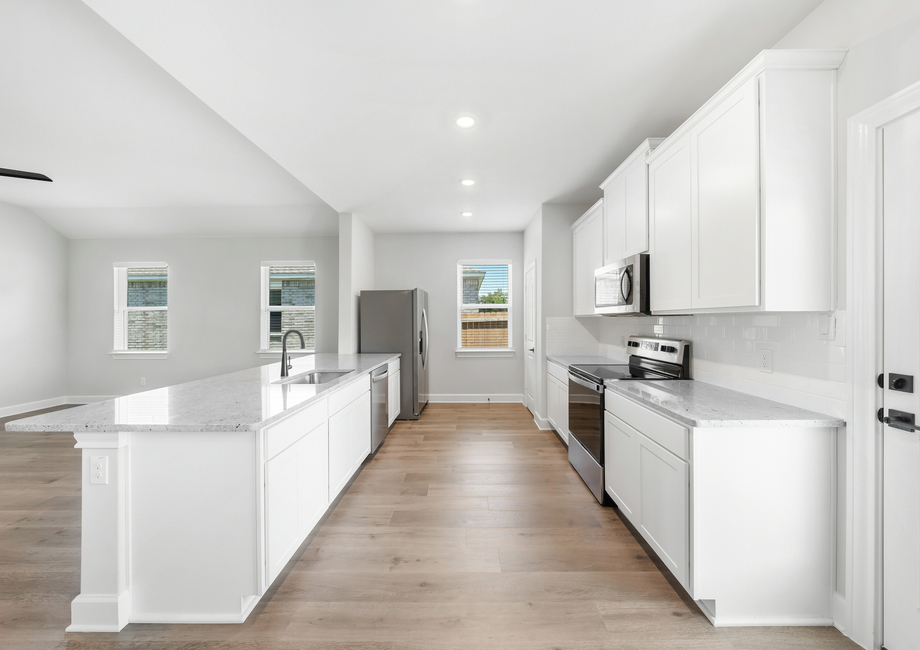 The kitchen of the Reed floor plan has energy-efficient appliances and white wood cabinetry.