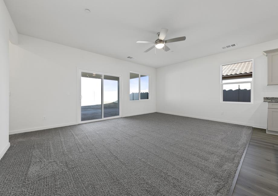 The family room is off of the kitchen and has a ceiling fan.