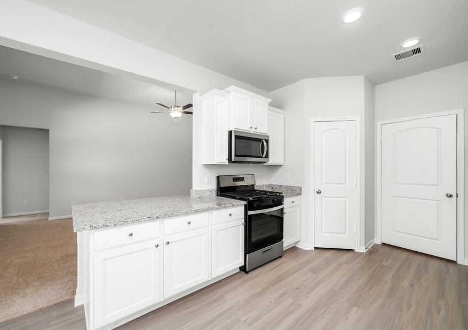 Chef ready kitchen with white cabinets and granite countertops