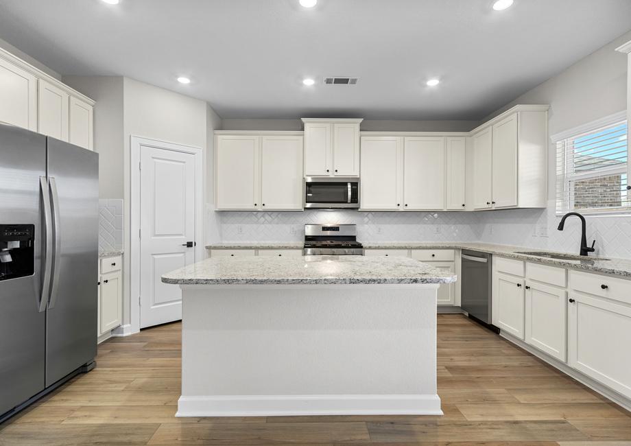 The kitchen features beautiful countertops for food prep.