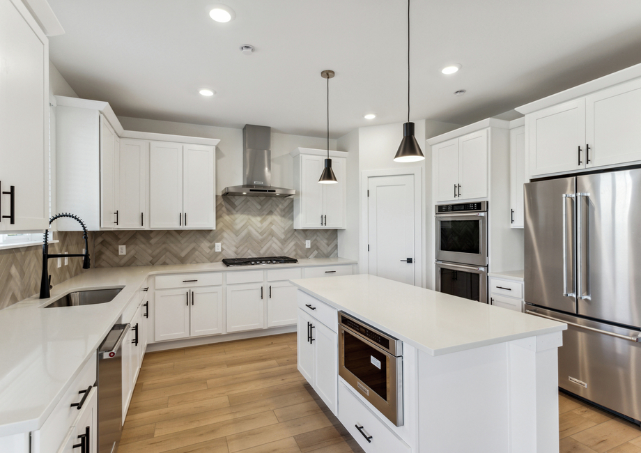 The beautiful kitchen has stainless steel, energy efficient appliances.