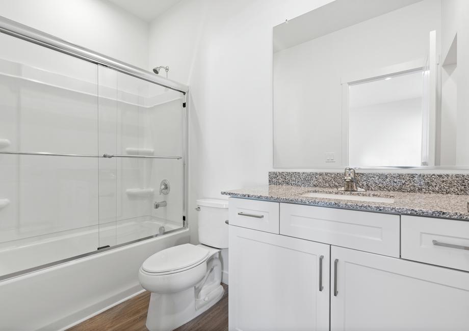 The gorgeous master bathroom includes a dual bathtub and shower as well as a walk-in closet