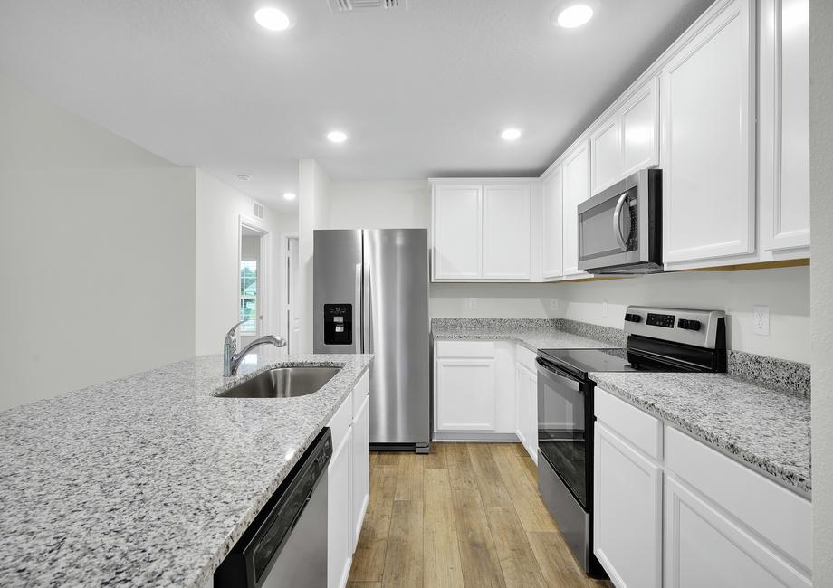 The kitchen is chef-ready with stainless steel appliances