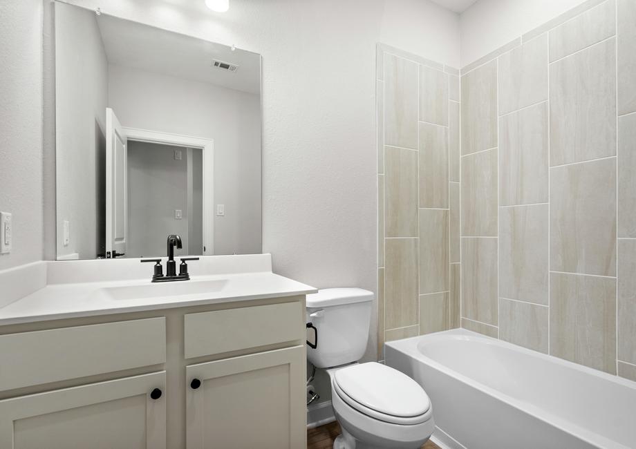 The guest bathroom comes equipped with necessities like a shower, bath, and full sink!