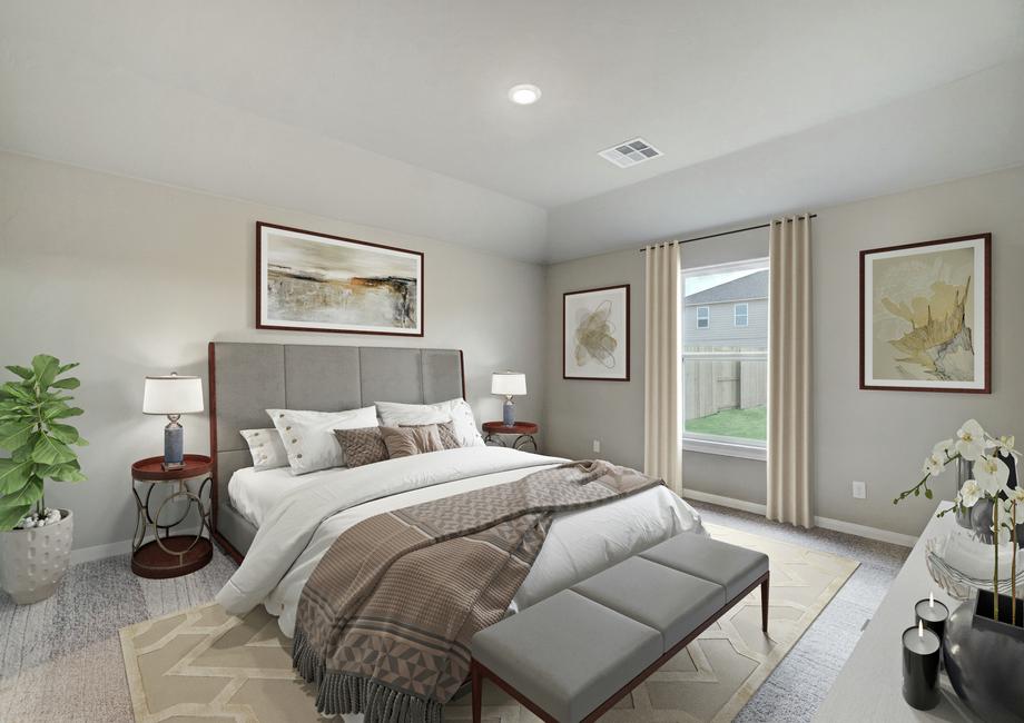 Staged bedroom with a gray bed with white linens.