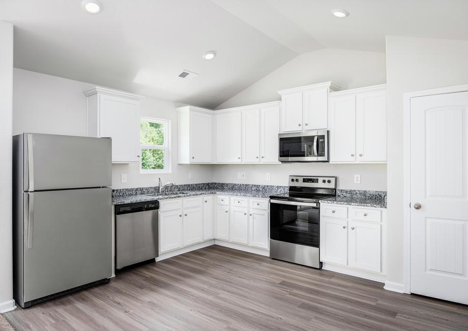 Kitchen with white cabinets and granite countertops.