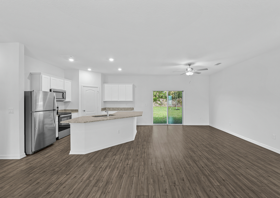 A kitchen with a large island that overlooks the dining room