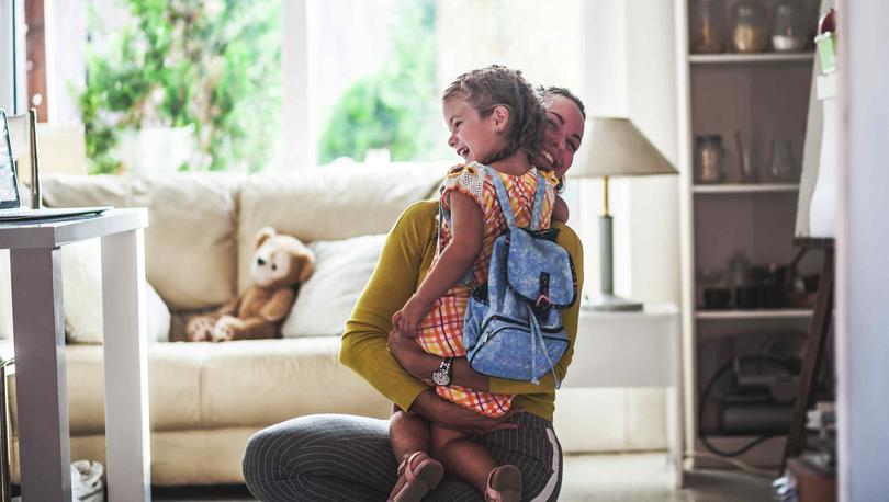 A mother hugging her daughter in their brand-new home.