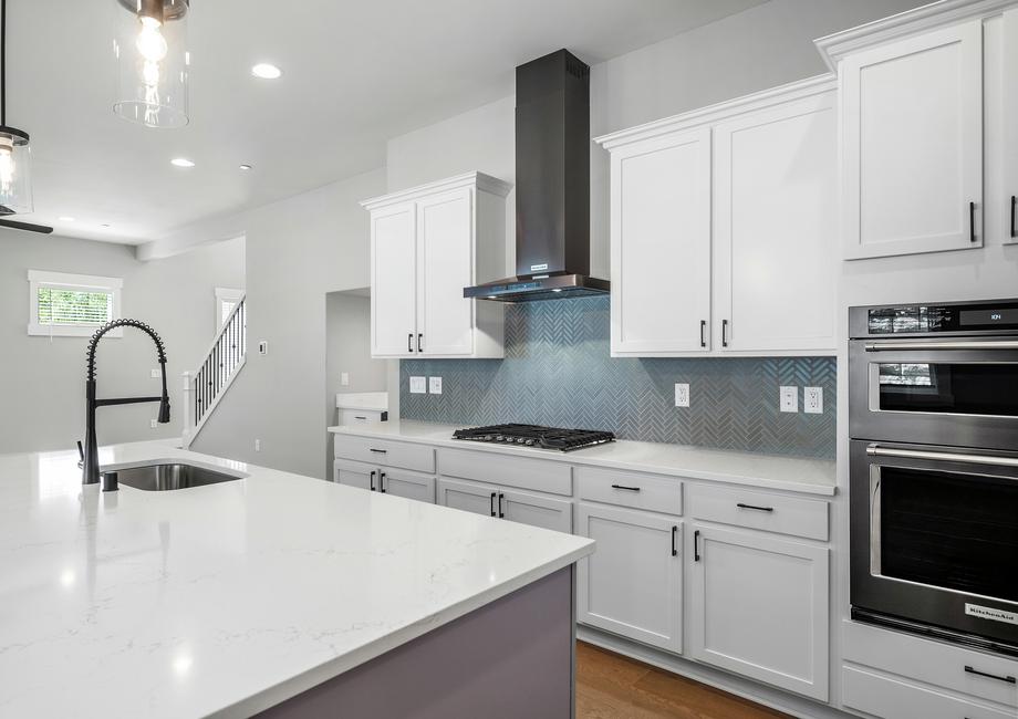 There is tons of storage in the kitchen with beautiful wood cabinets that include matte black hardware.