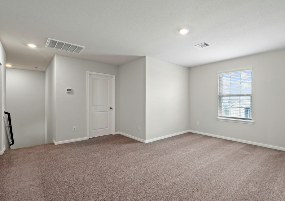 An upstairs game room with lush carpet