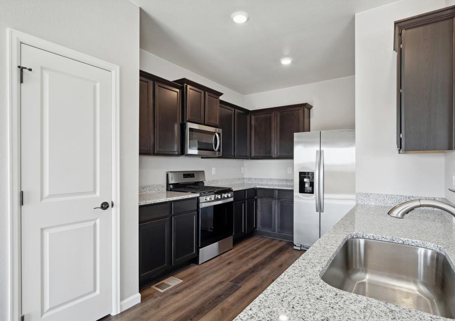 Upgraded kitchen with stainless appliances and granite countertops.
