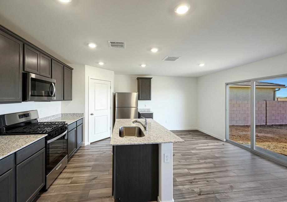 The kitchen has a beautiful granite island and a full suite of stainless steel appliances.