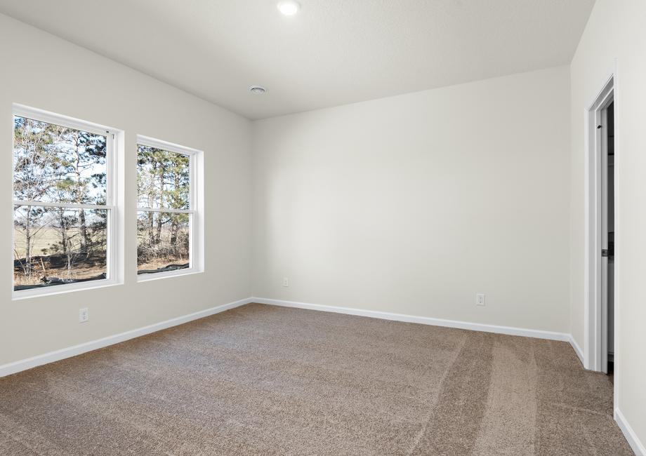 The master bedroom is spacious with large windows.