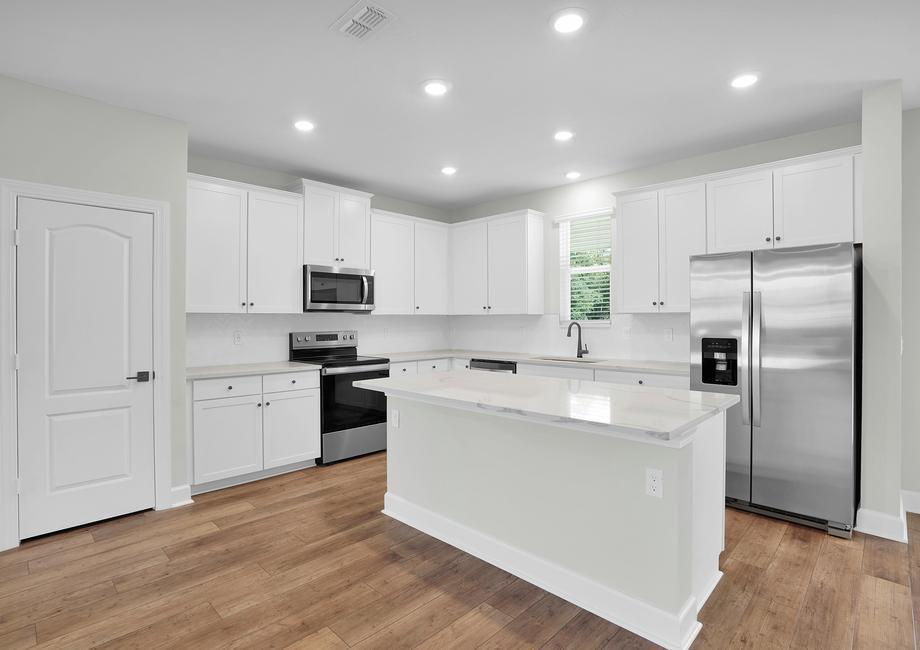 The kitchen has a large island that is ready to be the heart of your home