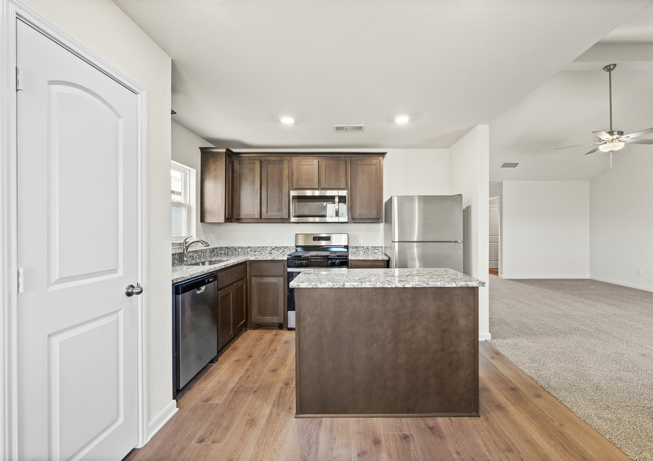 The kitchen has beautiful wood cabinetry.