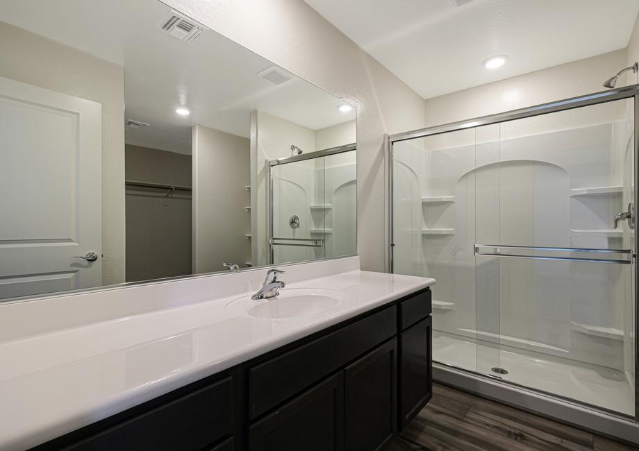 The master bath has a spacious, glass-enclosed shower.