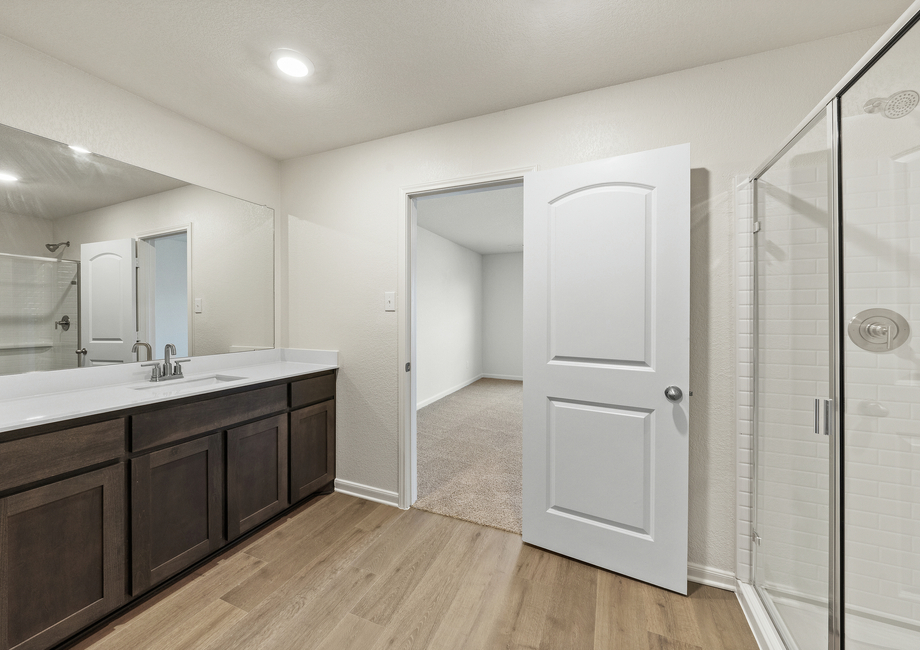 The master bathroom has a glass, walk-in shower.