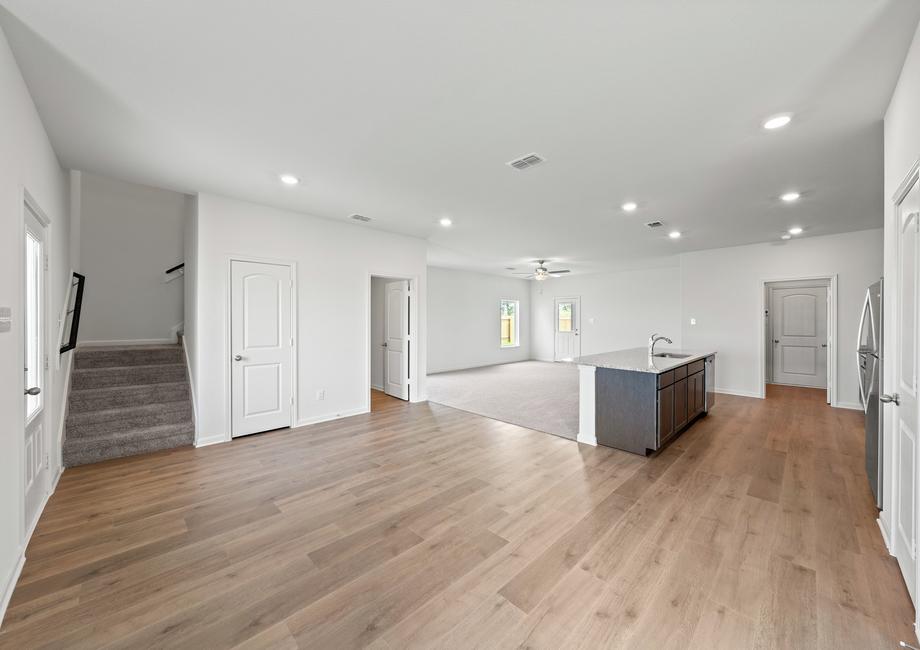 The open-concept layout of this floor plan has the kitchen, family room and dining room sitting next to one another.