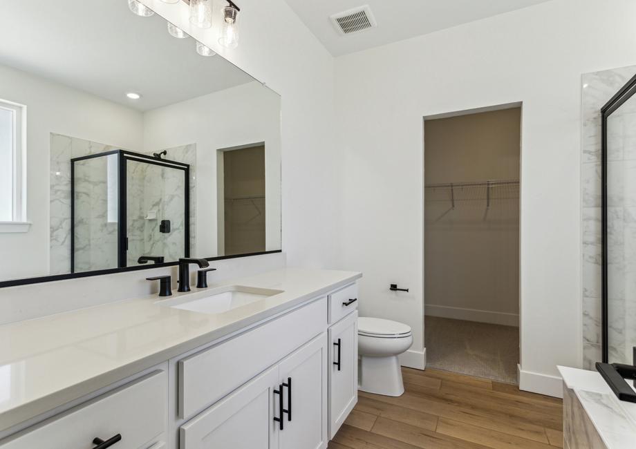 The master bathroom has a large vanity space.