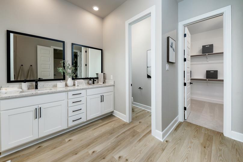 The large vanity in the master bath has granite countertops and black hardware.