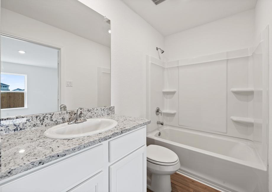 Master bathroom with granite countertops and a dual shower and tub.