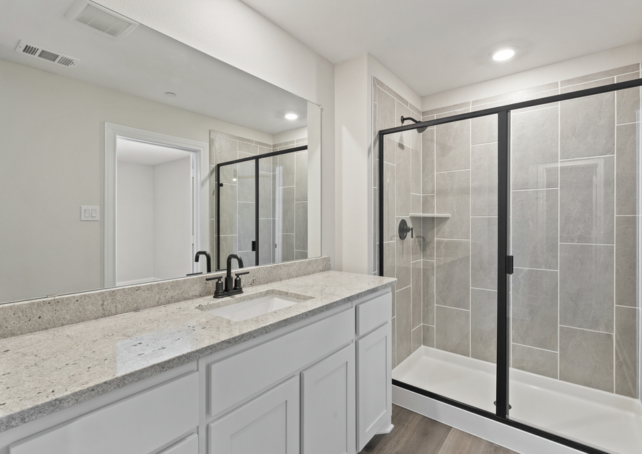 The master bathroom of the Noma has a large vanity space and a walk-in shower.