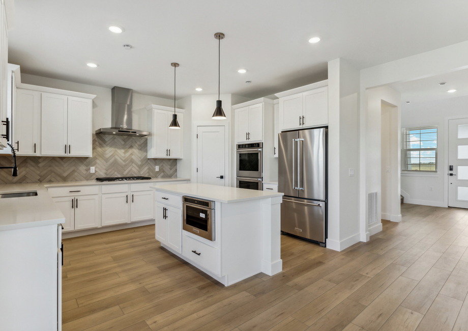 The beautiful kitchen has stainless steel, energy efficient appliances.