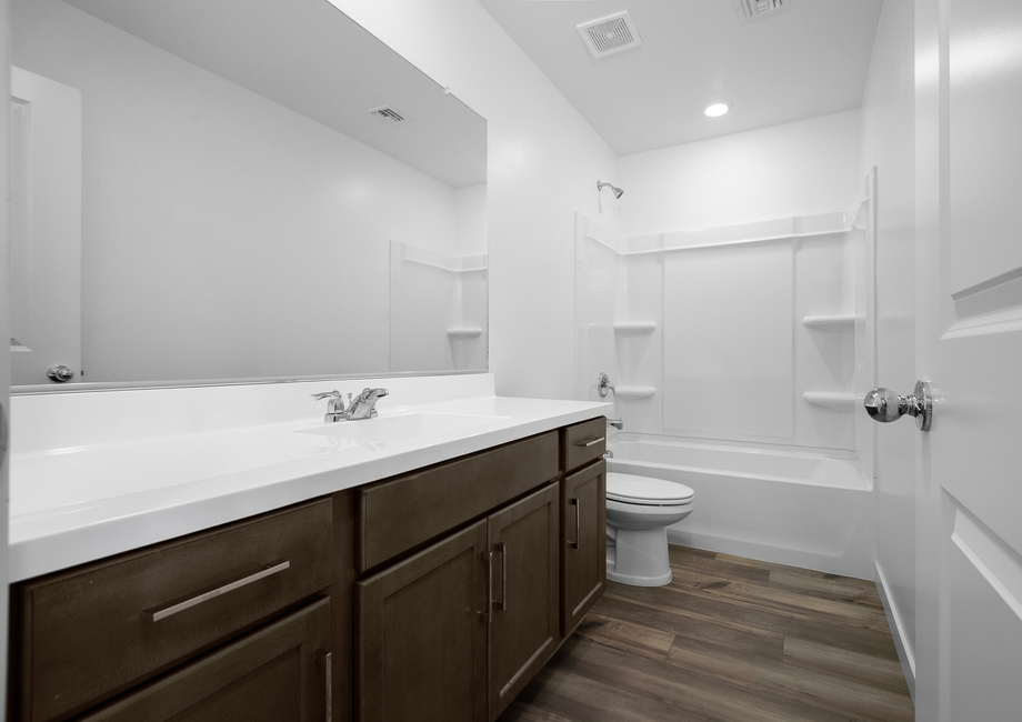 The guest bathroom has plenty of counterspace for comfort and convenience.