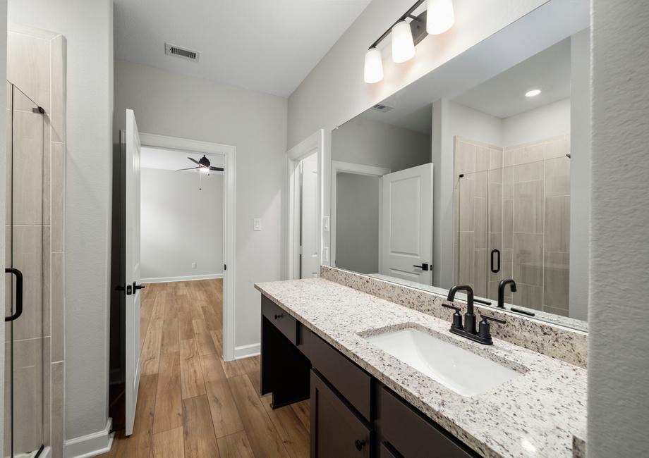 The master bathroom has a long vanity perfect for getting dressed each morning.