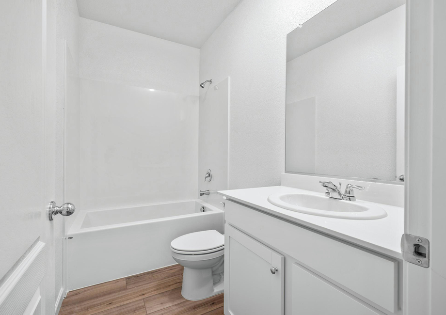 The secondary bathroom has a tub/shower combo and large vanity.