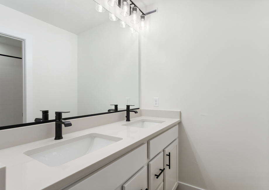 The secondary bathroom has a large vanity with lots of counterspace and a shower-tub combo.