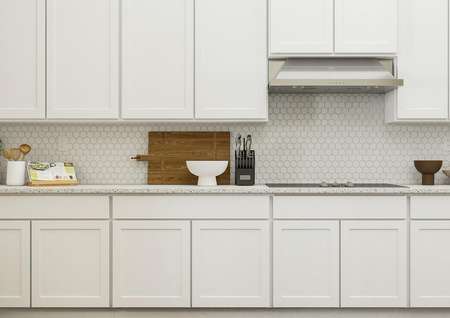 Rendering of spacious kitchen showing
  white cabinetry, a luxury tiled backsplash, glass stovetop and vent, and
  décor.