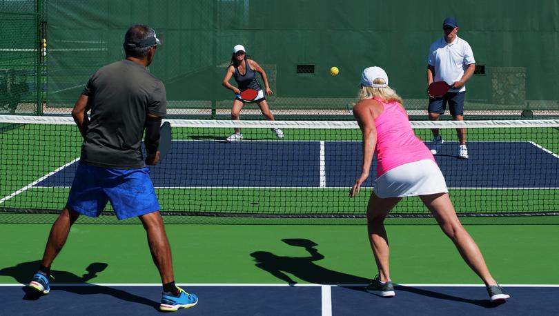 Friends playing pickleball.