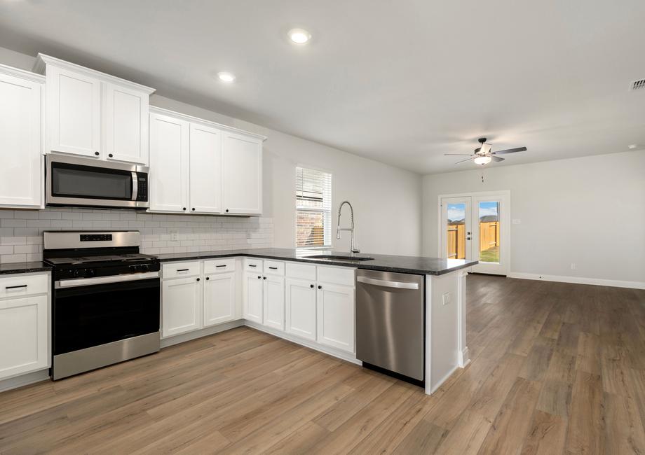 Chef-ready kitchen with white cabinets, granite countertops, and brand-new appliances.