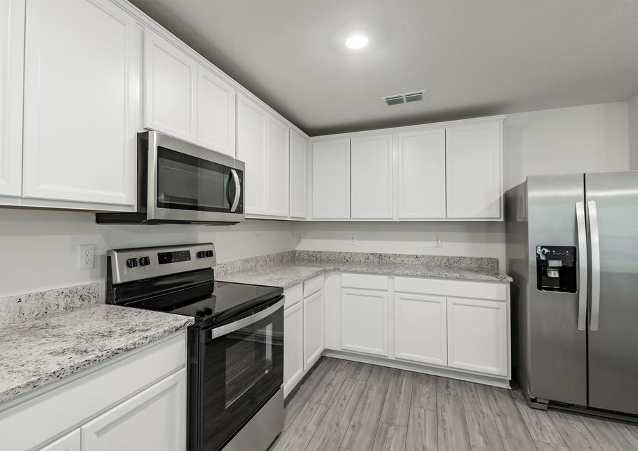 The kitchen is chef-ready with stainless steel appliances