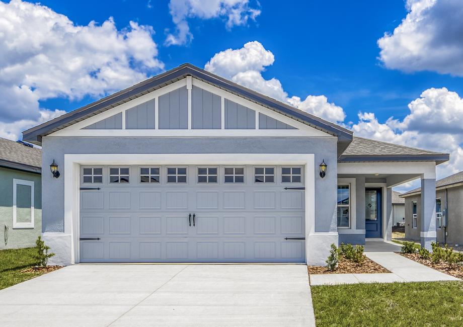 The exterior of the Pecan plan with blue stucco and white details