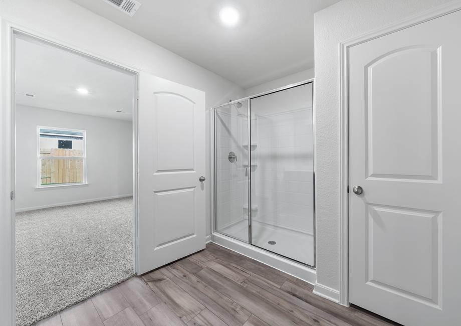 The master bathroom has a large walk-in, glass shower.