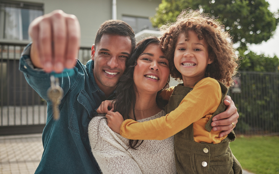 <p>Family in front of home with their keys.</p>