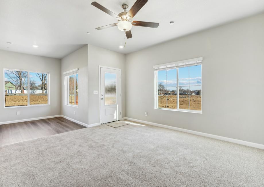 The family room is spacious and has a ceiling fan and is off to the dining area.